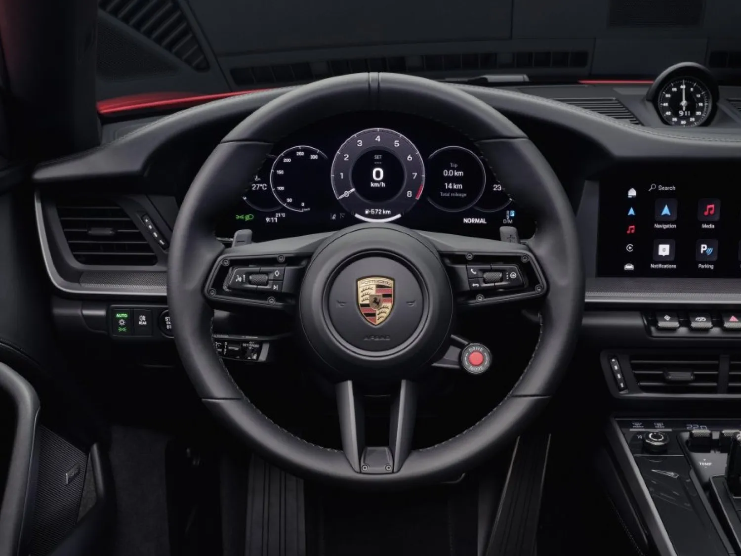 The Porsche 911 cockpit with the digital instrument cluster behind the steering wheel